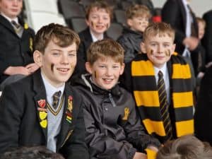 Happy school children in uniform smiling at Inchmarlo.