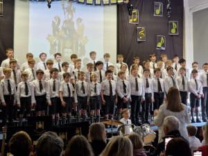 Students performing on stage at Inchmarlo School event.