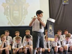 Young boy playing flute at Inchmarlo School event.