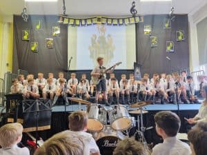 Children performing on stage during Inchmarlo music event in Scotland.