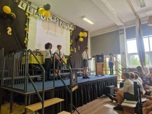 Students performing on stage at Inchmarlo school event.