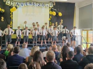 Students perform on stage during Inchmarlo school's graduation ceremony.