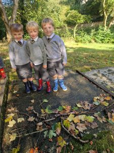 Three children playing outdoors in Inchmarlo woodland.