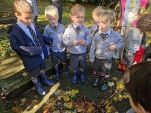 Children in school uniform exploring outdoors at Inchmarlo estate.