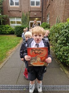 Young children walking outside Inchmarlo School in uniforms.