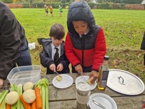 Children enjoying outdoor picnic with fresh fruits and condiments at Inchmarlo.