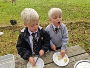 Two young boys having a picnic outdoors at Inchmarlo.
