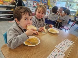 Happy children enjoying lunch at Inchmarlo childcare center.