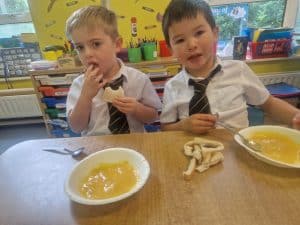 Two young children enjoying meal time at Inchmarlo preschool.