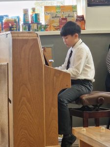 Young student practicing piano at Inchmarlo School in a classroom setting.