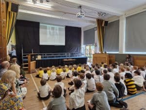 Children watching a presentation in a classroom setting.