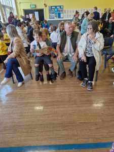 A group of children and parents gathering at Inchmarlo School for a community event.