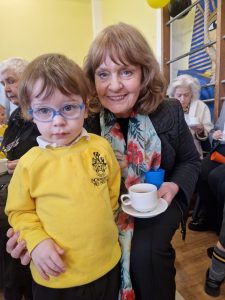 Smiling woman with child at Inchmarlo, Alzheimer’s charity event in Scotland.