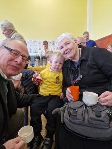 Smiling seniors and child enjoying a social gathering at Inchmarlo community center.