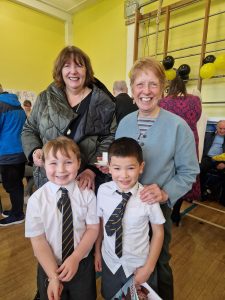 Joyful community at Inchmarlo care home with staff and residents enjoying activities.