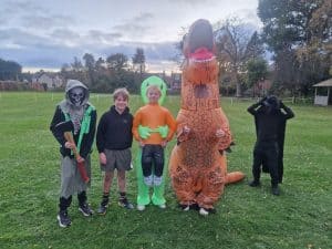 Happy children with fun costumes at Inchmarlo outdoor event.