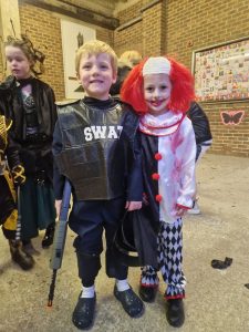 Kids dressed in costumes at Inchmarlo Halloween event for family fun and community celebration.