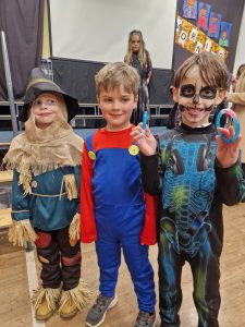 Kids in Halloween costumes celebrating at Inchmarlo event.