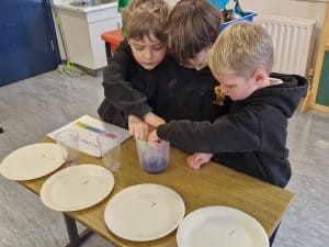 Children engaging in a hands-on activity at Inchmarlo School, fostering learning and creativity.