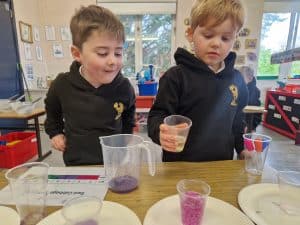 Two children engaging in a science experiment at Inchmarlo Outdoor Education Centre.