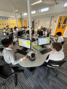Students working on computers in a classroom.