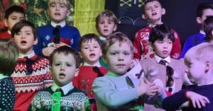 Children singing at Inchmarlo community event, showcasing local talent and community spirit.