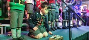 Children singing at Inchmarlo school event, showcasing children's choir performance.