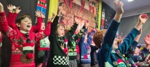 Vibrant Christmas celebration with children at Inchmarlo, festive holiday event in a joyful school setting.