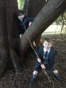 Cherished children playing in ancient woodland at Inchmarlo estate.