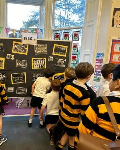 Students viewing historical displays on classroom board at Inchmarlo School.