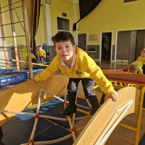 Young boy playing on indoor climbing frame at Inchmarlo.