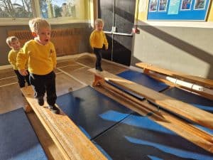 Children exploring wooden play structures at Inchmarlo resort. Fun-filled indoor activities for kids.