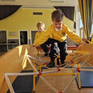Children playing on indoor climbing frame at Inchmarlo nursery.