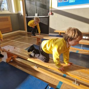 Children playing on wooden ramp at Inchmarlo preschool center.