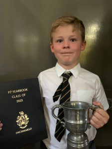 Young Boy Holding Trophy and Yearbook.