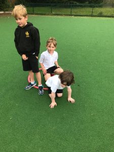 Children playing on a sports field at Inchmarlo School, promoting outdoor activity and fun.