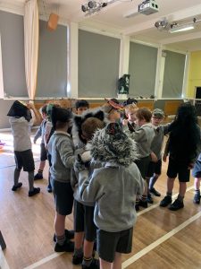 Children participating in an indoor activity at Inchmarlo School in a bright classroom.