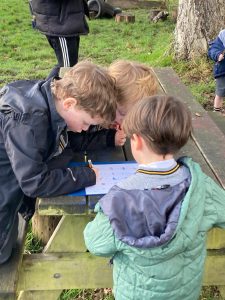 Children exploring nature at Inchmarlo, engaging in educational outdoor activities and learning in a scenic environment.