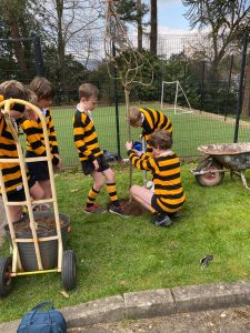 Children playing rugby in a lush green outdoor area at Inchmarlo.