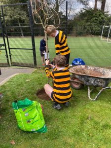 Young boy and girl in sports uniforms at outdoor football training session.