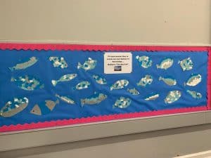 Colorful fish craft display at Inchmarlo school, showcasing creativity and student artwork.