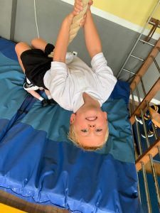Child lying on a padded mat during therapy session at Inchmarlo.
