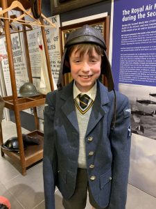 Young boy in school uniform at Inchmarlo Estate museum.