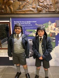 Two students in school uniforms at Inchmarlo, Aberdeenshire, inspiring education in scenic Scotland.