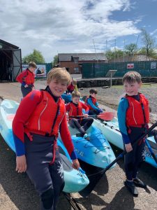 Children kayaking outdoor activity.