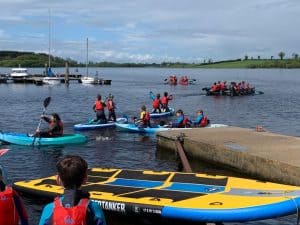 Group kayaking on Inchmarlo estate lake, outdoor adventure activities in Aberdeenshire.