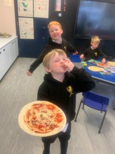 Children enjoying pizza at Inchmarlo Nursery in Scotland.
