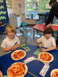 Children enjoying pizza at Inchmarlo care facility, promoting fun and engagement in a homely environment.
