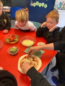 Children enjoying pizza at Inchmarlo educational center.
