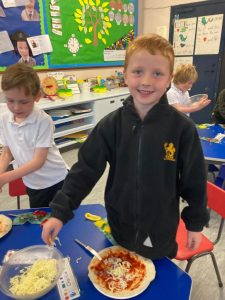 Young students enjoying pizza and activities at Inchmarlo School. Engaging learning environment for children.